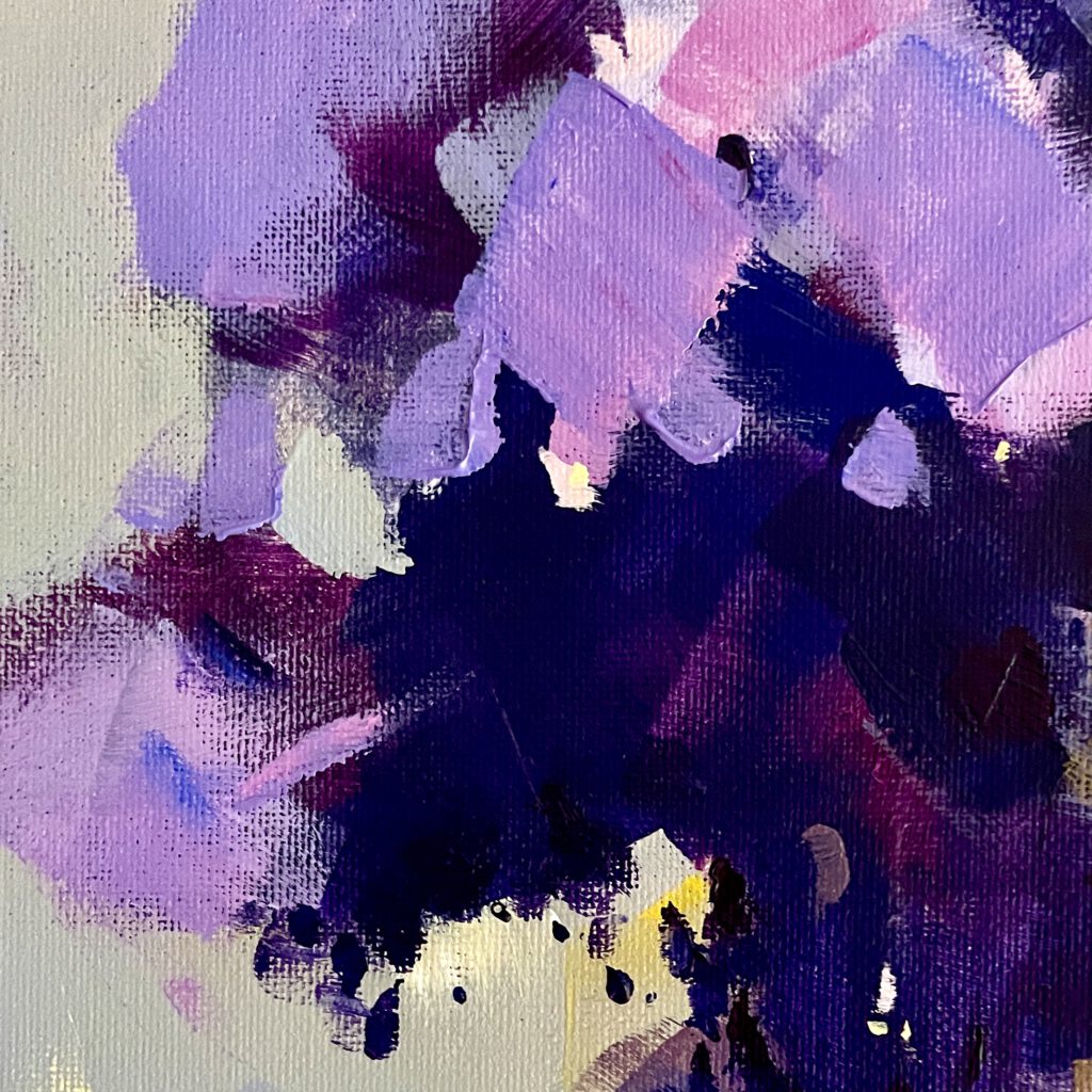 Abstract patches of acrylic paint in shades of purple and lilac, showcasing texture and color blending.